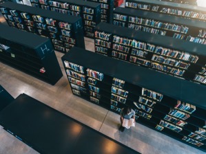 Female student at library bookshelf reading book 2022 02 02 05 07 31 utc