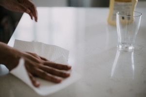 Hand wiping countertop with paper towel cleaning k 2022 11 11 08 54 14 utc