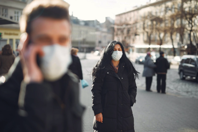 Banners and Alerts and Woman in Black Coat and Face Standing on Street Free Stock Photo