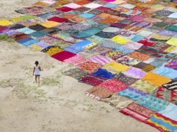 Boy by brightly coloured fabric squares laid out o 2022 03 04 02 45 12 utc