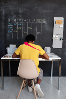 Boy in Yellow Crew Neck T shirt Sitting on Chair Free Stock Photo