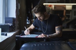 Caucasian tattoo artist designing motifs on digit 2022 03 17 14 48 18 utc