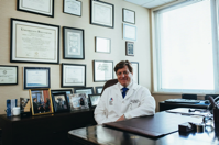 Doctor Sitting in Front of His Desk Free Stock Photo