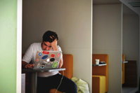 Man in White Shirt Using Macbook Pro Free Stock Photo
