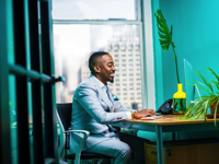 Man Sitting in Front of Keyboard Free Stock Photo