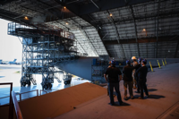Photo By Senior Airman Marco Gomez | Team Dover Airmen and the T-Mobile customer discovery team tour the Isochronal Maintenance Dock on Dover Air Force Base, Delaware, Oct. 20, 2021. The T-Mobile team met with Dover AFB Airmen to discuss new innovative ways to enhance mission effectiveness and accelerate change in meaningful ways. (U.S. Air Force photo by Senior Airman Marco A. Gomez) 