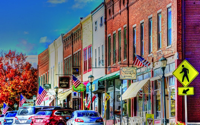 Small Down Street with US Flags flying from the buildings.