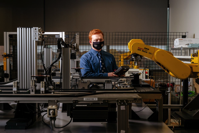 Matthew Henry’s education at Oakland University was made possible, in significant part, by the school’s partnership with Siemens. He sits with a robot controller connected to a conveyor system in a lab on campus.
PHOTO: NICK HAGEN FOR THE WALL STREET JOURNAL