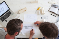 people looking at a blueprint.