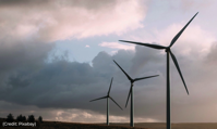 3 Windmills against a cloudy sky