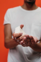 Person in White Crew Neck T shirt Holding Bar Soap Free Stock Photo