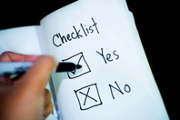 Person Marking Check on Opened Book Free Stock Photo