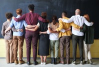 diverse group of people standing arm in arm