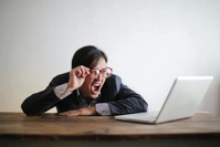 Woman screaming at computer.