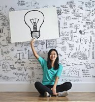 Girl holding up a lightbulb