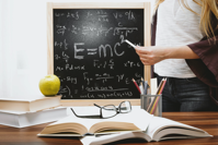 Chalkboard with e=mc2 on it.