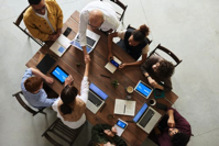 people in meeting around a conference table.