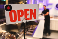 Open sign with a store as the backdrop.
