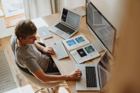 Person setting at desk with computers.