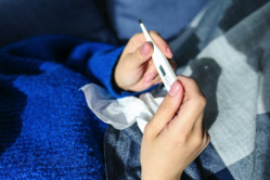 Sick ... person holding thermometer.