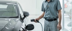 Senior asian technician is charging the electric c 2021 08 30 13 14 59 utc