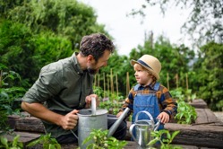 Small boy with father gardening on farm growing o 2022 02 02 03 56 30 utc