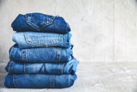 Stack of blue jeans on a gray background 2021 08 26 18 09 20 utc