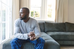 Thoughtful african american man sitting on couch l 2022 01 18 23 46 25 utc