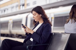 Two businesswomen commuting to work waiting for tr 2021 12 09 15 25 17 utc