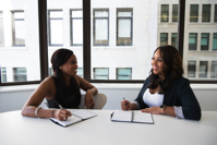 Two Woman in Black Sits on Chair Near Table Free Stock Photo