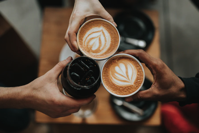 people toasting with coffee drinks