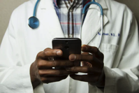 Doctor holding cell phone.