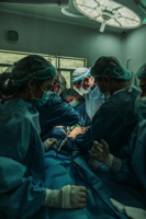 Doctors and nurses performing surgery.