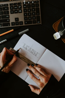 desktop with a person writing the word learn