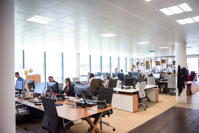 Office workspace filled with workers.