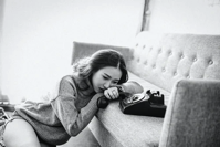 butnout.- woman on couch with phone