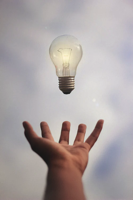 Hand holding light bulb