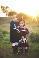 Kids reading a book.