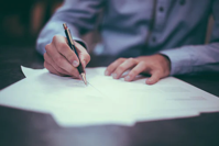 Man putting pen to paper
