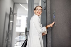 Woman entering code on the building entrance 2021 12 09 04 27 47 utc