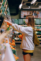Woman in White Long Sleeve Jacket Shopping For Fruits Free Stock Photo
