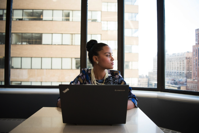 Woman Sits in Front of Black Laptop Computer Free Stock Photo