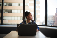 Woman Sits in Front of Black Laptop Computer Free Stock Photo