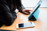 Woman With Phone and Tablet on Table Free Stock Photo